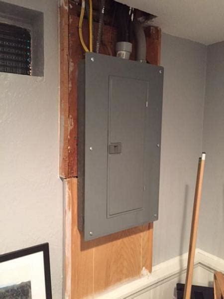 add enclosure over electrical panel|putting a cabinet over an electrical panel.